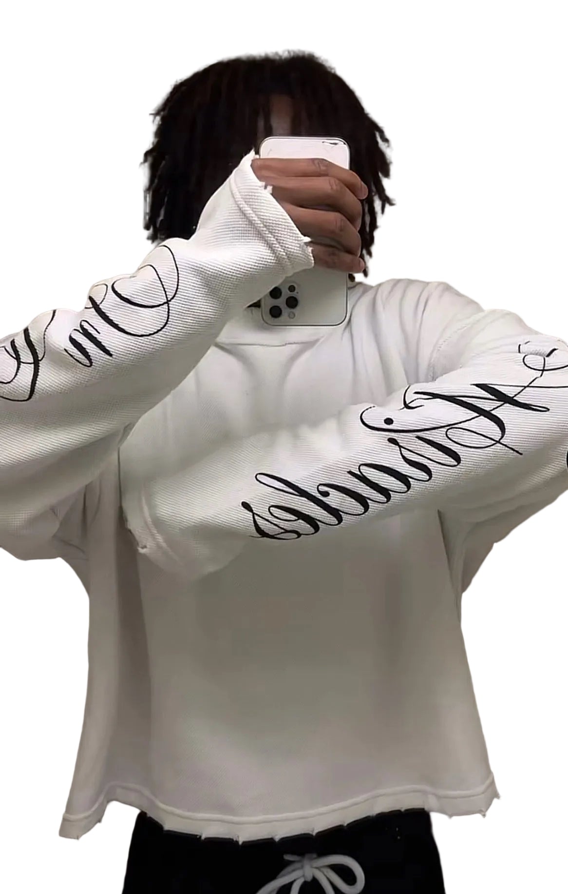 Person wearing a white hoodie with black text, taking a mirror selfie.